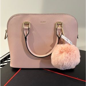 Pink Aldo purse with strap for crossbody styling.